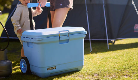 Pro Wheeled Cooler on Grass being pulled my mother and son.